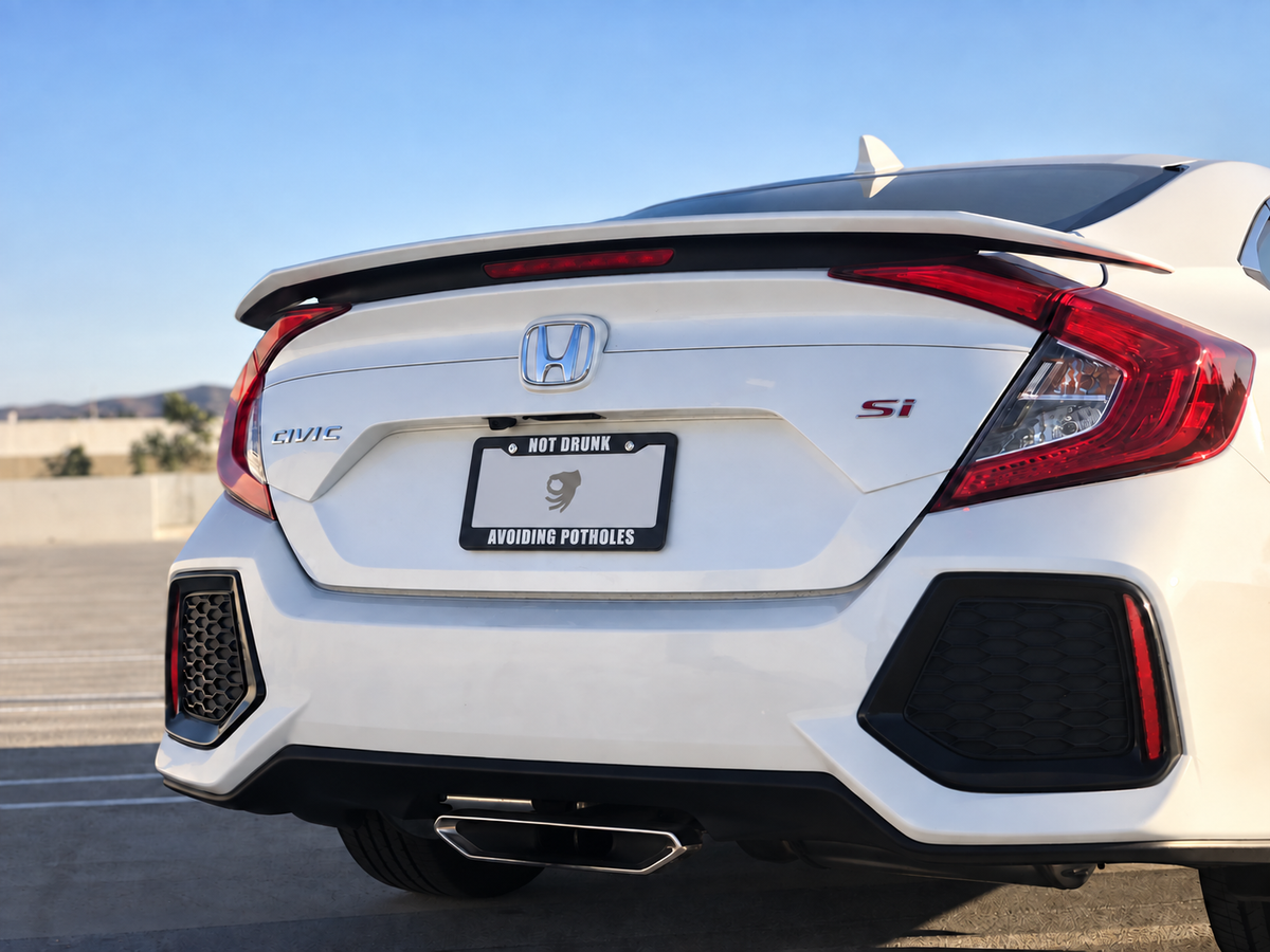 Not Drunk, Avoiding Potholes license plate frame installed on a car
