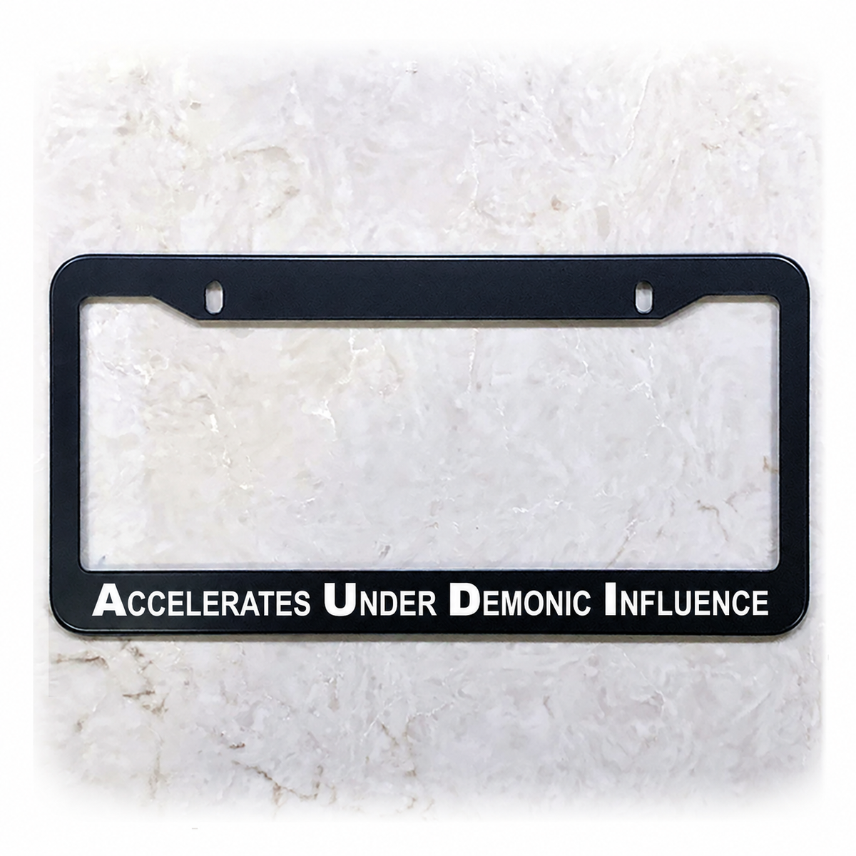 Accelerates Under Demonic Influence license plate frame in stainless steel