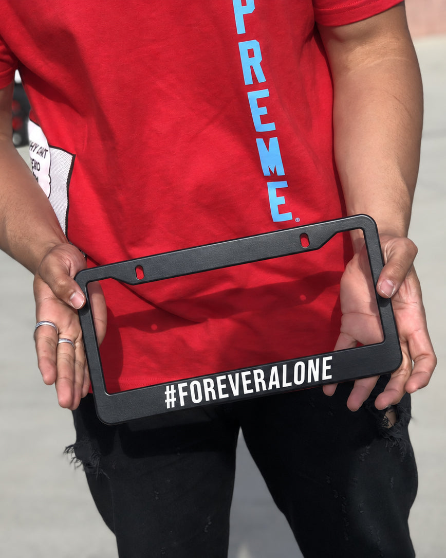 Forever Alone license plate frame held by a person