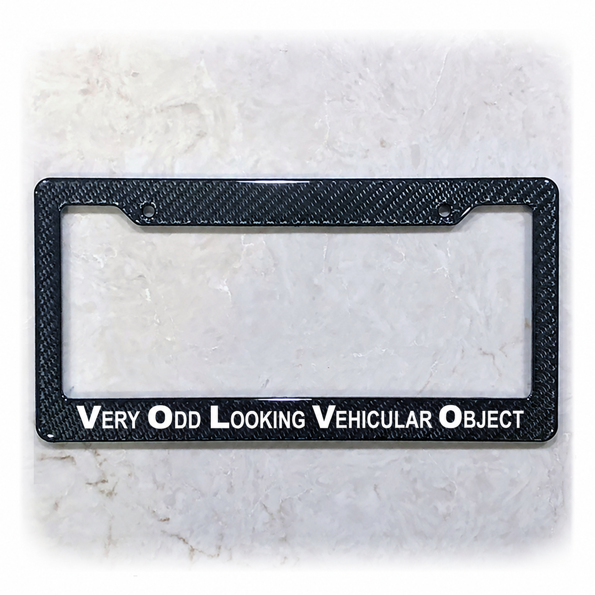 Very Odd Looking Vehicular Object license plate frame in carbon fiber overlay on ABS