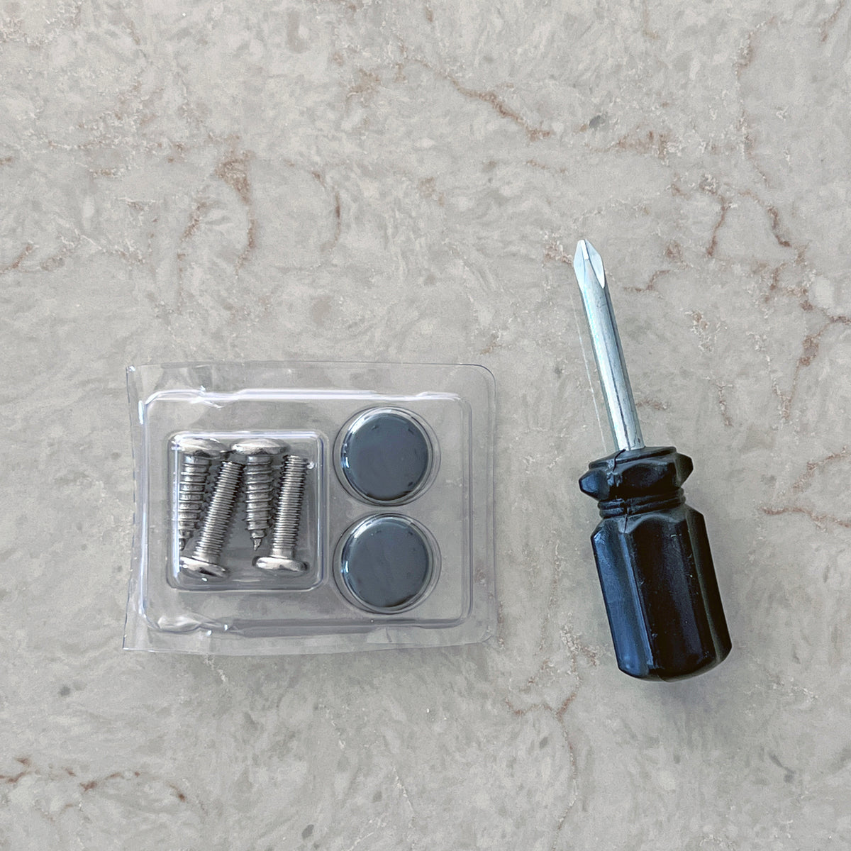 License plate frame mounting hardware and mini screwdriver